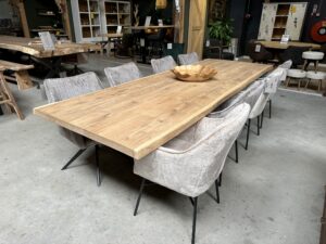 Boomstamtafel met matrixpoot in de winkel van Bouwie. Aan de tafel staan 4 stoelen aan iedere zijde